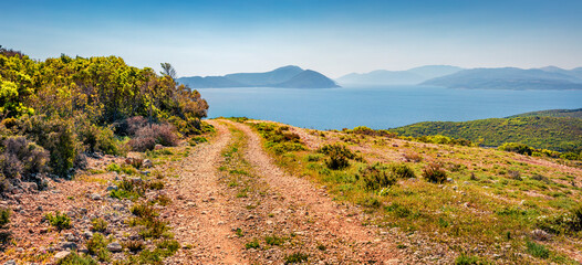 Fototapeta premium Colorful morning panorama of Ionian islands with old country road. Splendid spring view of Lefcada island, Greece, Europe. Amazing seascape of Ionia Sea. Beauty of nature concept background.