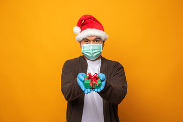 Young asian man in christmas day holding the present gift box on