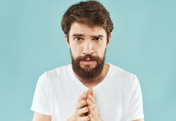 Emotional bearded man on a blue background cropped view of gesticulating with his hands