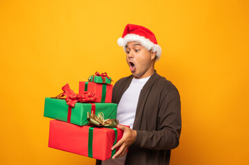 Happy excited asian man in new year's christmas day holding the