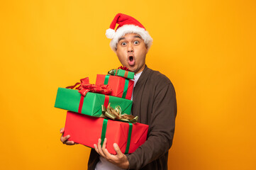 Happy excited asian man in new year's christmas day holding the