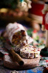 Christmas chocolate salami on a Christmas rustic background