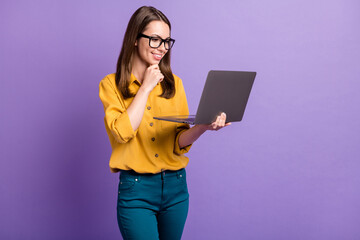 Photo of pretty young girl arm chin hold computer toothy smile wear glasses yellow shirt blue pants...