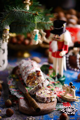 Christmas chocolate salami on a Christmas rustic background