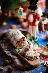 Christmas chocolate salami on a Christmas rustic background