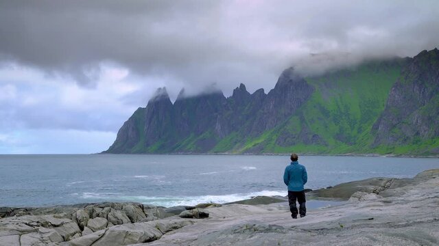 Hiker looks out at epic wild landscape