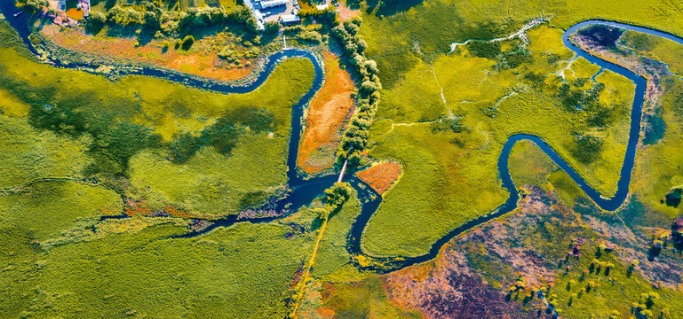 Straight dawn panoramic view from flying drone of bridge over Seret river, Ternopil region, Ukraine, Europe. Exciting summer scene of green flooded valley. Beauty of nature concept background.