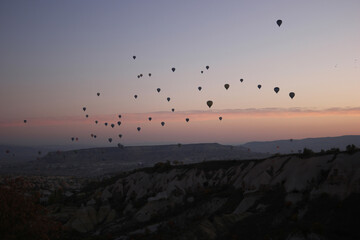 Hot air balloons festival at Cappadocia. Flight of hot air balloons at evening sky. The most breathtaking scene.