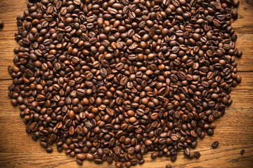 Fresh coffee beans on wood and linen bag, ready to brew delicious coffee