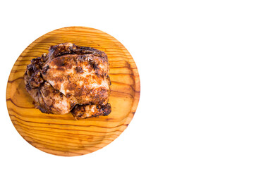 Roast chicken on a wooden tray on white background