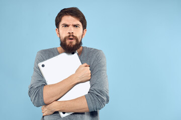 Bearded man laptop in hand internet wireless technology emotions blue background