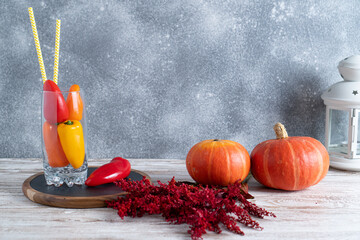 Various autumn seasonal organic vegetables on white wooden table. Red dried flower. Fall decor concept