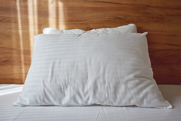 White pillow on bed in apartment bedroom