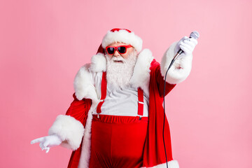 Cool funky white grey beard hair santa claus big abdomen enjoy x-mas christmas party live concert sing song microphone wear suspenders sunglass headwear isolated pastel color background
