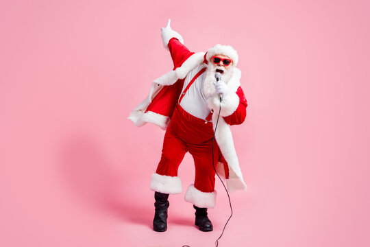 Full length photo crazy north-pole celebrity grey beard santa claus big belly sing song mic christmas x-mas eve wear suspenders sunglass stylish cap boots isolated pastel color background