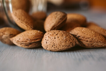 Almonds in a jar on wooden rustic table as background. Close up view. 