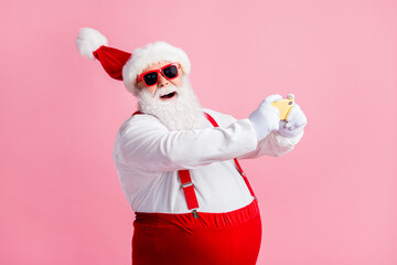 Profile side view portrait of his he cheerful bearded fat overweight Santa using cell browsing post social network blog 5g app fast speed having fun air blow wind isolated pink pastel color background