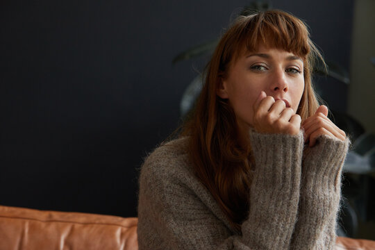 Woman in a cashmere sweater sitting at home