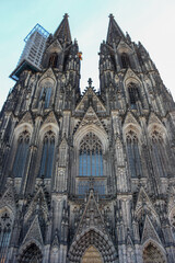 Fototapeta premium The facade of Cologne Cathedral (Kolner Dom), Roman Catholic cathedral church. It is the largest Gothic church in northern Europe.