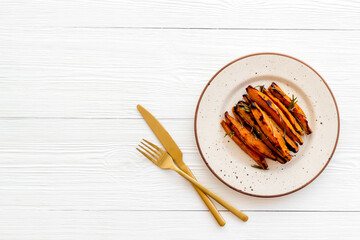 Overhead view of sweet potato fries with spices and herbs