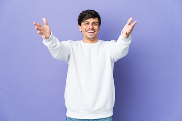 Young cool man feels confident giving a hug to the camera.