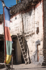 Chhyangur, Lower Mustang. Flags and ladder of old buddhist house.