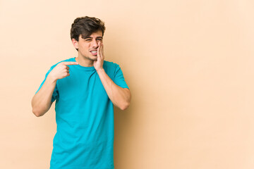 Young cool man having a strong teeth pain, molar ache.