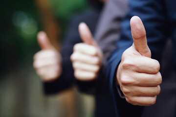 Businessman cool show hand giving thumb up as sign of Success