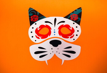 flatlay false paper photo booth props for Dia de los Muertos on orange background copyspace for Day of the dead greeting card