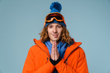 Caucasian pleased sportsman posing with palms together