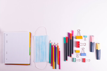 different stationary items of various colours on light surface.