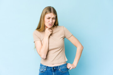 Young blonde woman isolated on blue background suffers pain in throat due a virus or infection.