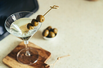 COvid-19 concept - quarantini drink martini via online communication with tablet, kitchen background