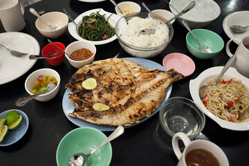 Close-up view of the several dishes menu on a table of a popular fish restaurant in Makassar, Sulawesi, Indonesia
