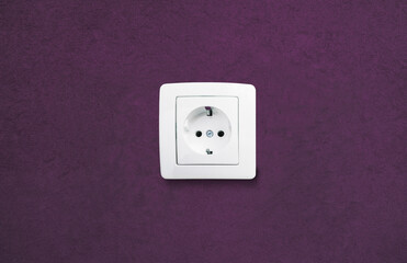 white electrical outlet on dark wall