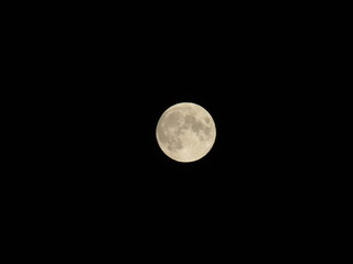 Genova, Italy - 09/25/2020: An amazing photography of the full moon over the city of Genova by night with a great clear sky in background and some stars