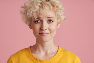 Portrait of a young blonde girl with curly blonde hair