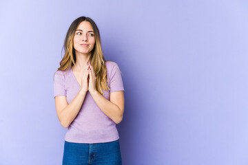 Young caucasian woman isolated on purple background making up plan in mind, setting up an idea.