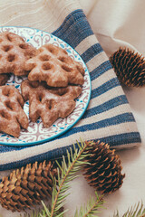 Ginger cookies in a plate on the tablecloth.