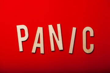 panic word text wooden letter on red background