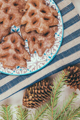 Ginger cookies in a plate on the tablecloth.