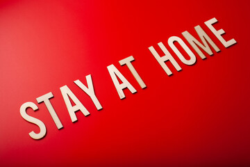 stay at home word text wooden letter on red background coronavirus covid-19