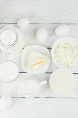 Fototapeta premium Different dairy products on the white wooden boards