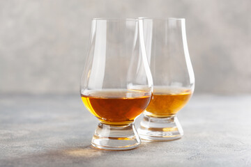glass of whisky spirit brandy on gray concrete background