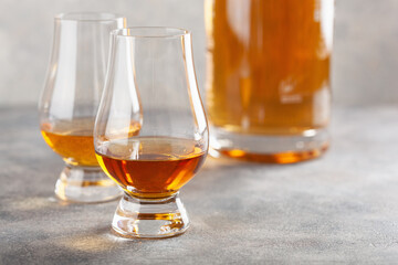 glass of whisky spirit brandy on gray concrete background