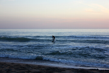 Fototapeta premium Surfing in corona times at Forte dei Marmi, Tuscany, Italy