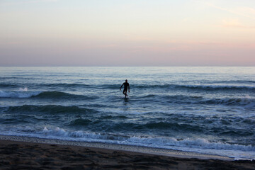 Surfing in corona times at Forte dei Marmi, Tuscany, Italy