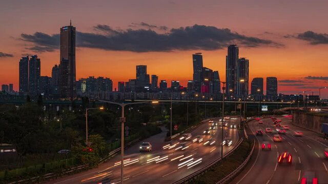Traffic during sunset at Han river side. and skyscraper business and financial office beautiful construction at seoul city south korea(zoom out)