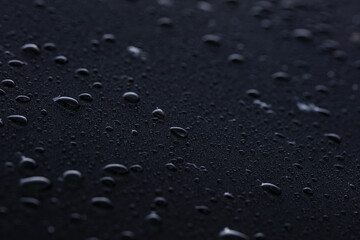 Closeup of water drops on car after rain