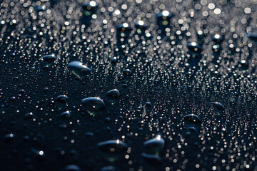 Closeup of water drops on car after rain